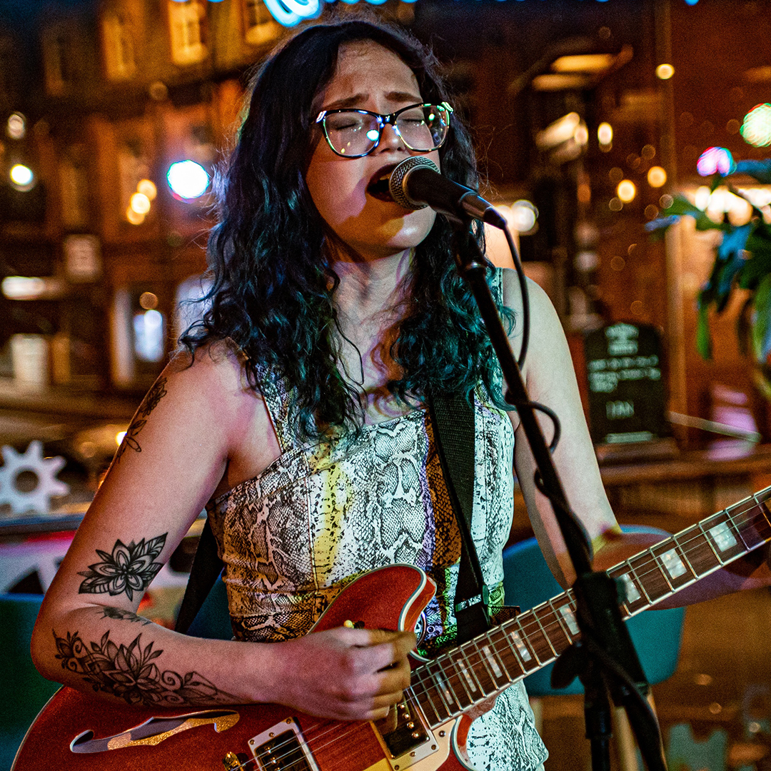 Tammy Wilde performing live with her guitar